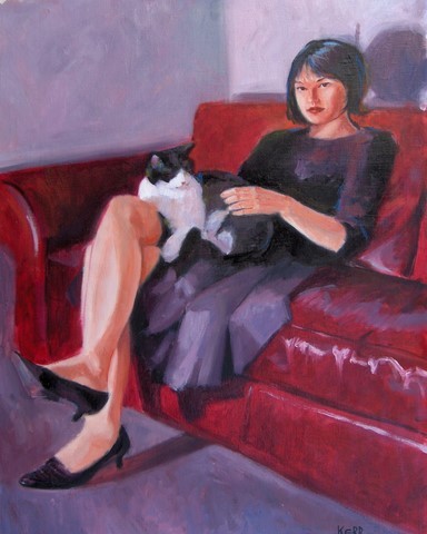 girl with cat on red sofa