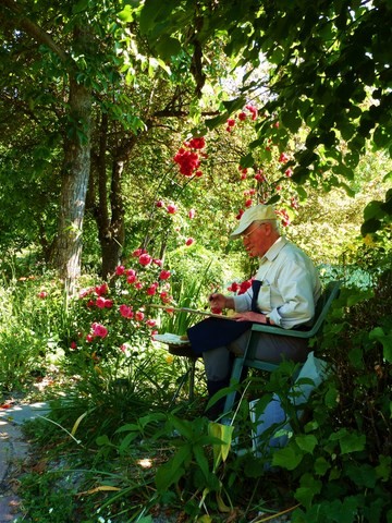 man painting in the garden