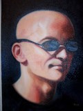 portrait man with shaved head and sunglasses