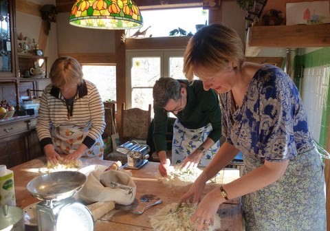 three people making pasta