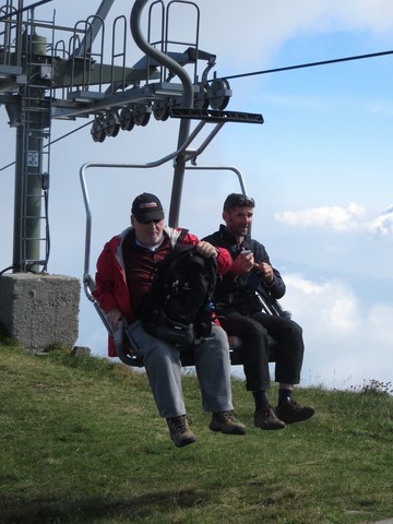 Two men ready to get off the chair lift